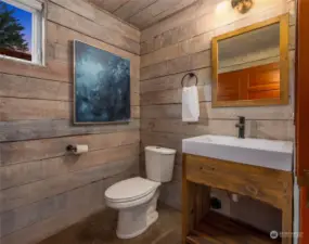 The main level of the home also includes a convenient powder room, with classic fixtures, and abundant storage under the stairwell.