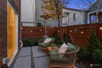 Outside is a fully fenced private patio ringed by carefully cultivated landscaping that augments the appeal of the space.