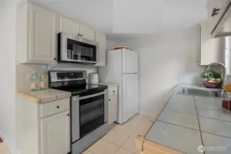 The kitchen looks out to the privacy of the fenced yard.