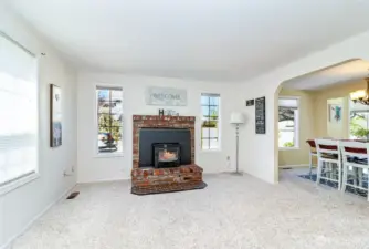 Formal Living Room~Real Brick Fireplace & Hearth with a Wood Burning Insert~North Facing & Easily Flows into Arched Dining Room Entry~