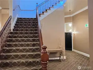 3rd floor landing with elegant staircase to the 4th floor and door to end condo unit 302.