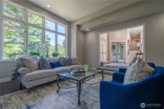 View of the living room located just off the entry.  The door to the right of the front door is the main floor den.  the stairs lead to the 3 guest bedrooms and full bath.
