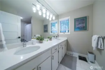 Updated Full Guest Bath with dual vanity, tub/shower, updated flooring, lighting and more.