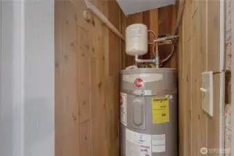 Newer Water heater with required pan and seismic straps, located in a closet near the front door.