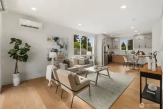 High ceilings, recessed lighting, and a harmonious palette of light-toned walls and floors create a bright, airy feel, while ductless mini-splits provide efficient heating and cooling year-round.