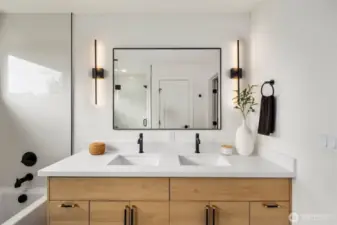 Sleek and functional, the double-sink vanity offers generous cabinet space, modern vertical lighting, and a huge mirror—perfect for two to get ready in comfort and style.