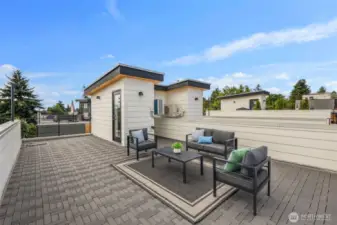 The generous layout offers room for both seating and dining areas, making it ideal for entertaining under the sky.