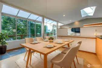 The bright eating area off the kithchen is a great way to start the day with the warmth of the skylight, outdoors, trees and views