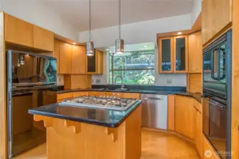 Highly functional contemporary kitchen offers plenty of storage, space for a couple barstools and cubbies to hide counter items