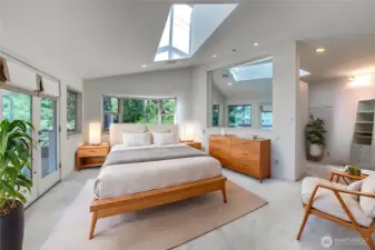 The contemporary primary bedroom offers a spacious oasis for the new owner