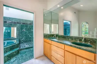 The primary bath offeres classic marble, a sunken tub, high celings and plenty of space to prepare for the day