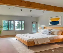The lower floor bedroom has access to the lower deck, view windows and is very private