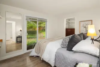 Primary bedroom has a walk-in closet and slider door that leads to the completely private backyard.