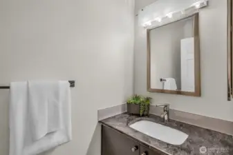 Powder room with granite counters.
