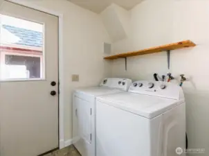 Door in laundry leads to fenced dog run between home and garage.