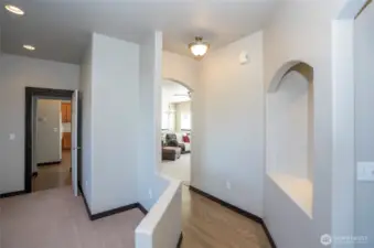 Hallway that flows into the open family and kitchen areas, creating a seamless and connected layout.