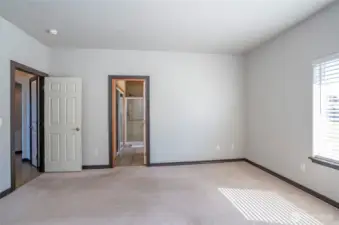 Additional view of the bright primary suite featuring a private ensuite bathroom.