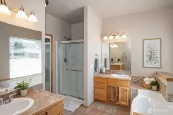 Primary ensuite featuring a walk-in shower and dual sinks for added comfort and convenience.