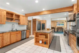 Rich knotty alder cabinetry elegantly accentuates the bountiful granite countertops