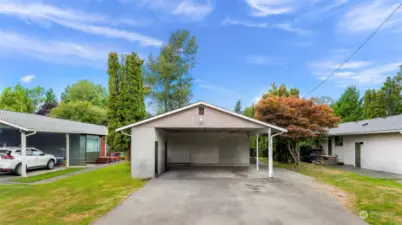 Storage closets on the left side of the covered parking area