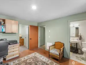 Den/Office/Guest room showing ensuite to right, hallway center, extra finished room thru door to left.