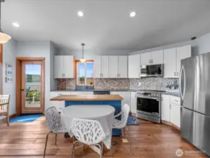 Solid reclaimed wood floors flow through the main level. Door to the left opens to the deck to enjoy views/bbq/entertaining .