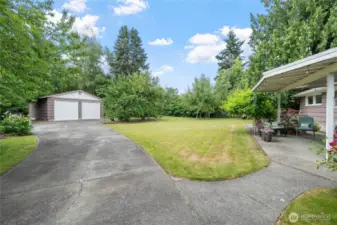 Spacious backyard with a covered patio, lush lawn, and easy access to the 24' x 32' detached garage.