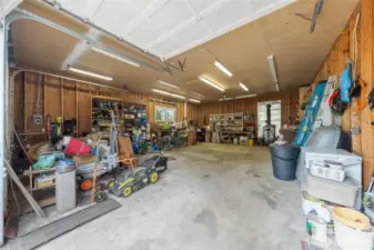 Huge 24' X 32' garage with 10ft high doors.  2 work benches, 220 wiring and wood stove.