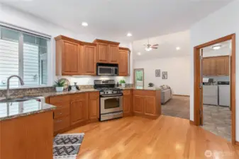 Cook's kitchen w/ oak floors, stone counters and stainless appliances