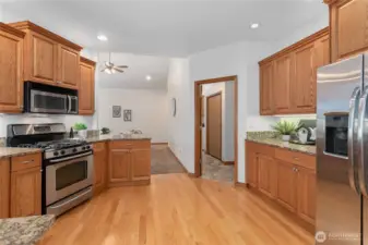 Kitchen leads to generous walk-in utility room and attached garage