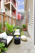 Small patio and yard outside the lower level bedroom.  Fully fenced.