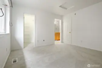 The primary bedroom has a walk-in closet and access to a full bathroom.  New carpet in this room.