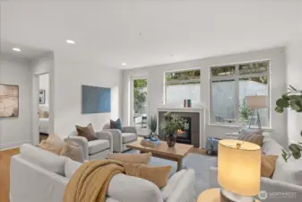 Generous living area anchored by cozy gas fireplace . . .south facing windowed wall . .