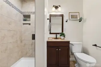 Downstairs bathoom/laundry room includes shower