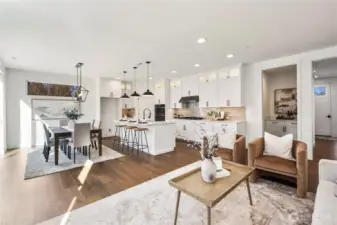 Dining to Great Room:  The dining area seamlessly flows into the great room, with large sliding glass doors inviting views of the landscaped rockery and fully fenced backyard. This open layout allows you to host with ease while maintaining clear sightlines across the main living spaces. Surrounded by the greenery and convenience of Bothell’s Canyon Park neighborhood, the home sits moments from local trails, community parks, and key commuter routes. The modern chandelier, wide-plank floors, and natural light combine to create a bright, welcoming space that adapts beautifully to everyday life.    These photos are from Lot 5 at Gooden Hollow, the home listed here. However, other homes in the community will have changes, so all photos, renderings, site maps, and floorplans are for visualization purposes only. Plans, colors, building orientation, finishes, home outlook, and other details can and WILL vary.