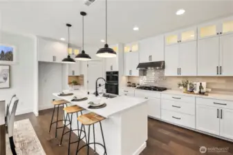 Kitchen & Dining Overview:  This combined kitchen and dining area is framed by expansive windows and sliding glass doors that bring in soft natural light and connect the interior to the private backyard. The generous layout allows for a full-size dining table while maintaining clear sightlines to the kitchen and great room. Nestled within Bothell’s Canyon Park area, the space offers a convenient balance between neighborhood living, commuter access, and the outdoor recreation that defines the PNW lifestyle. Its clean lines, warm flooring, and contemporary lighting create a welcoming setting for gatherings of all sizes.    These photos are from Lot 5 at Gooden Hollow, the home listed here. However, other homes in the community will have changes, so all photos, renderings, site maps, and floorplans are for visualization purposes only. Plans, colors, building orientation, finishes, home outlook, and other details can and WILL vary.