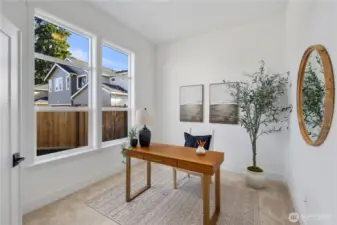 Den / Home Office:  Tall windows frame greenery and bring natural light into this spacious den, creating an inviting setting for focused work, creative projects, or quiet reading. Located on the main level and separate from the guest bedroom, it provides the additional dedicated space today’s lifestyles often require. Its position in Bothell’s Canyon Park neighborhood keeps you close to trails, local cafés, and community conveniences, enriching both productivity and day-to-day living. With its clean lines and modern proportions, this den offers a flexible, elevated workspace.    These photos are from Lot 5 at Gooden Hollow, the home listed here. However, other homes in the community will have changes, so all photos, renderings, site maps, and floorplans are for visualization purposes only. Plans, colors, building orientation, finishes, home outlook, and other details can and WILL vary.