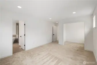 Primary Suite – Expanded View:  This wider perspective highlights the suite’s spacious layout, recessed lighting, and direct connection to the spa-inspired bath and attached sitting room. Its thoughtful floorplan promotes easy flow between rest, dressing, and relaxation areas. Being part of the Canyon Park community in Bothell means the suite sits moments from everyday conveniences, Northshore schools, and outdoor recreation. The overall scale invites a sense of calm and allows you to shape the space to match your preferred style of retreat.    These photos are from Lot 5 at Gooden Hollow, the home listed here. However, other homes in the community will have changes, so all photos, renderings, site maps, and floorplans are for visualization purposes only. Plans, colors, building orientation, finishes, home outlook, and other details can and WILL vary.