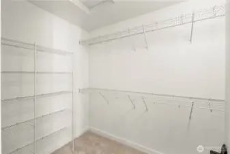 Primary Walk-In Closet:  The walk-in closet offers extensive built-in shelving and hanging space, creating an organized extension of the primary suite. Its layout maximizes capacity while keeping everything within easy reach. Thanks to the home’s location in Bothell’s Canyon Park area, the suite benefits from a peaceful residential environment close to shopping, cafés, and community conveniences. This well-sized closet adds everyday ease and helps maintain the calm, uncluttered feel throughout the suite.    These photos are from Lot 5 at Gooden Hollow, the home listed here. However, other homes in the community will have changes, so all photos, renderings, site maps, and floorplans are for visualization purposes only. Plans, colors, building orientation, finishes, home outlook, and other details can and WILL vary.