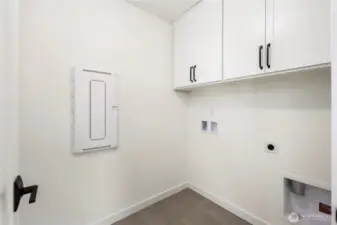 Laundry Room (Washer/Dryer Wall):  This dedicated laundry area includes upper cabinetry for organized storage and durable tile flooring designed for everyday function. Its location on the upper level keeps daily routines easy and efficient. With quick access to both Canyon Park conveniences and major Eastside routes, household tasks feel streamlined and integrated into daily living. The neutral palette and clean lines make it simple to pair with your preferred appliances and organizational systems.    These photos are from Lot 5 at Gooden Hollow, the home listed here. However, other homes in the community will have changes, so all photos, renderings, site maps, and floorplans are for visualization purposes only. Plans, colors, building orientation, finishes, home outlook, and other details can and WILL vary.