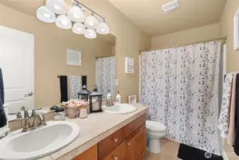 Full second-level bathroom with tile finishes.