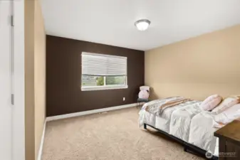 Spacious additional bedroom overlooking the backyard with walk-in closet.