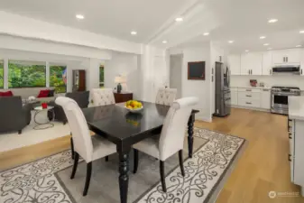 A large breakfast nook provides enough space to be used as a formal dining room, perfect for entertaining, and is bracketed by a full-wall buffet counter