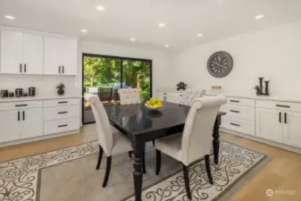 A large breakfast nook provides enough space to be used as a formal dining room, perfect for entertaining, and is bracketed by a full-wall buffet counter