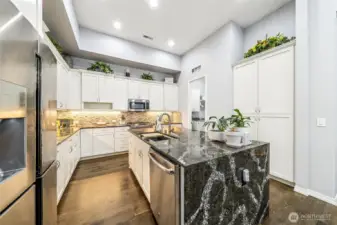 Another view of the kitchen with laundry room in the background