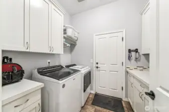 Laundry room between kitchen and garage with even more storage space.