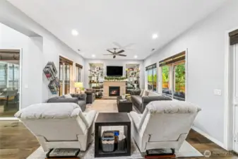 Great room with gas fireplace and covered/ enclosed side deck to the left.