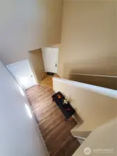 View of the front door/main level entry from atop the stairs.