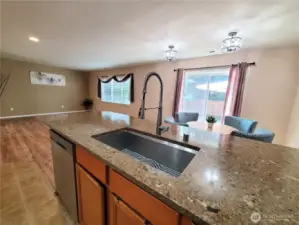 Kitchen overlooks the living room, dining room and sliding door to the deck.