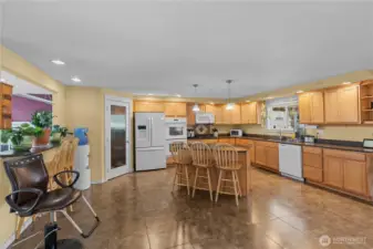 Kitchen on the upper level features an island bar and also a 2nd bar eating area at the pass through to the dining room. There's even space for an additional small table if you desire.